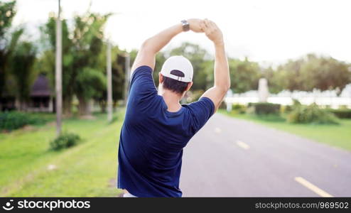 Asian man prepares for a workout at the public park, vintage colors.