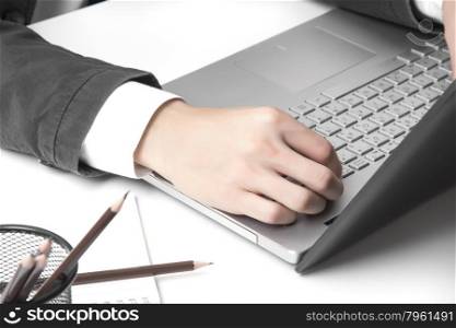 Asian man&rsquo;s hands typing on laptop keyboard