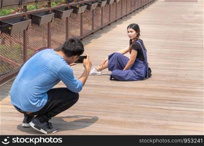 Asian man who are taking picture of his lover. Travel photography concept.