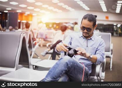 Asian man with backpack traveler using the smart mobile phone for Video call and taking at an airport,Blurry and soft focus