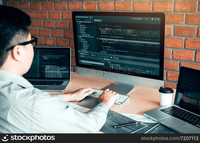 Asian man working code program developer computer web development working design software on desk in office.