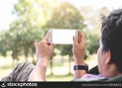 Asian men are using smartphone in the park.