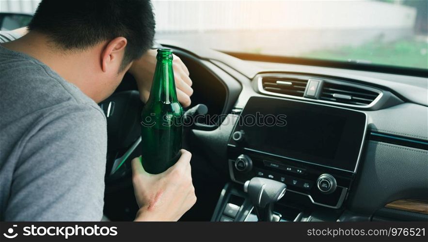 Asian men drink a lot of alcohol until and unconscious his can't drive home and decide to sleep at the steering wheel.