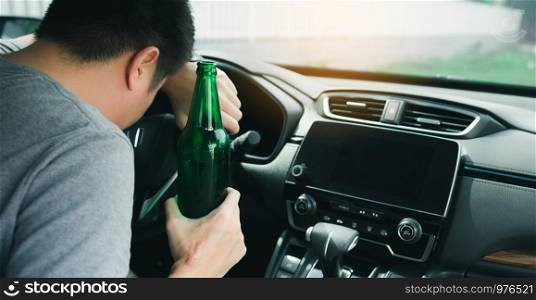 Asian men drink a lot of alcohol until and unconscious his can't drive home and decide to sleep at the steering wheel.