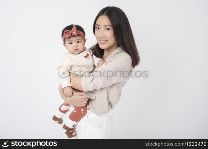 Asian mother and adorable baby girl are happy on white background