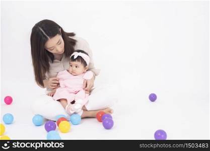Asian mother and adorable baby girl are happy on white background