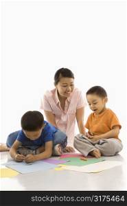 Asian mother with boys coloring.