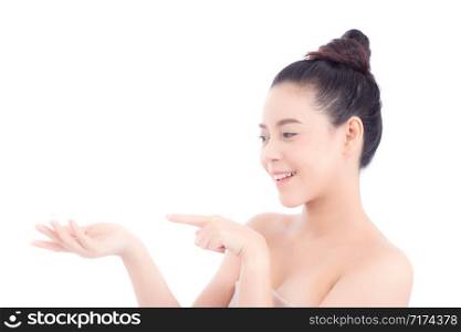 Asian of portrait beautiful young woman showing with healthy clean skin presenting something empty copy space on the hand isolated on white background, beauty concept.