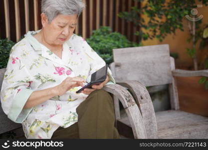 asian old elder senior woman elderly male using mobile smart phone cellphone outdoor. mature retirement lifestyle