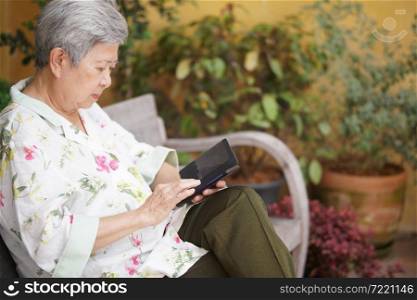 asian old elder senior woman elderly male using mobile smart phone cellphone outdoor. mature retirement lifestyle