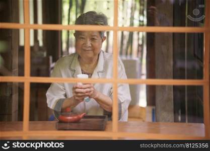 asian old elderly female elder woman drinking hot tea. senior leisure lifestyle