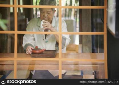 asian old elderly female elder woman drinking hot tea. senior leisure lifestyle