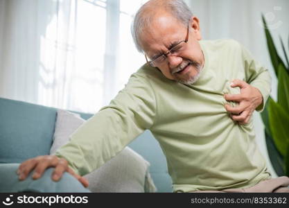 Asian older man have congenital disease suffering from heartache alone at home, Senior man bad pain hand touching chest having heart attack, Old age retirement health problems unhealthy diseased