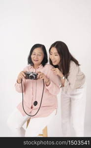 Asian older woman and her daughter on white background, Travel concept