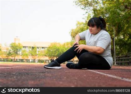 Asian overweight woman a new runner pain ankle during running, Athlete runner training accident. Sport running ankle sprained sprain cause injury. weight loss, workout, sports, health care concepts