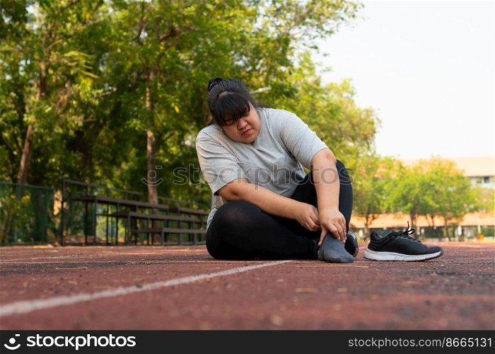 Asian overweight woman a new runner pain ankle during running, Athlete runner training accident. Sport running ankle sprained sprain cause injury. weight loss, workout, sports, health care concepts