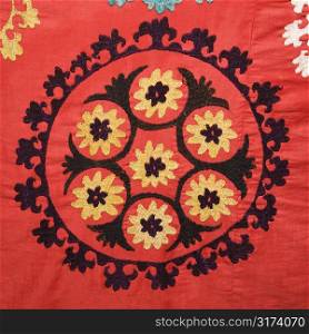 Asian pattern on red textile fabric.