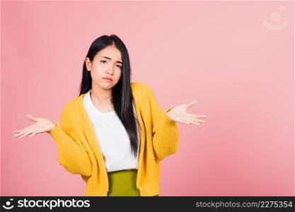 Asian portrait beautiful cute young woman teen shrugging with spread hands she shocked dont understand and confused studio shot isolated on pink background, female doubt with copy space