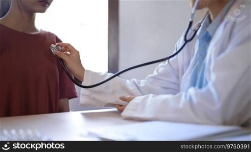 Asian psychologist women use stethoscope to examining heartbeat of patient and giving counseling about mental health therapy while female patient stress and anxiety with psychological health problem.