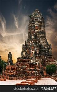 Asian religious architecture. Ancient Buddhist pagoda ruins at Chai Watthanaram temple under sunset sky. Ayutthaya, Thailand travel landscape and destinations