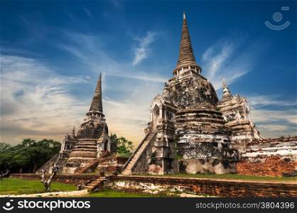 Asian religious architecture. Ancient Buddhist pagoda ruins at Wat Phra Sri Sanphet temple under sunset sky. Ayutthaya, Thailand travel landscape and destinations