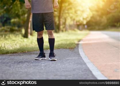 Asian Runner man running in city park morning outdoors