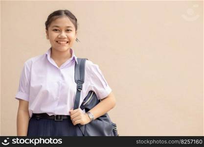 Asian School girl teen cute student in uniform happy smile with bag looking camera with space for text.