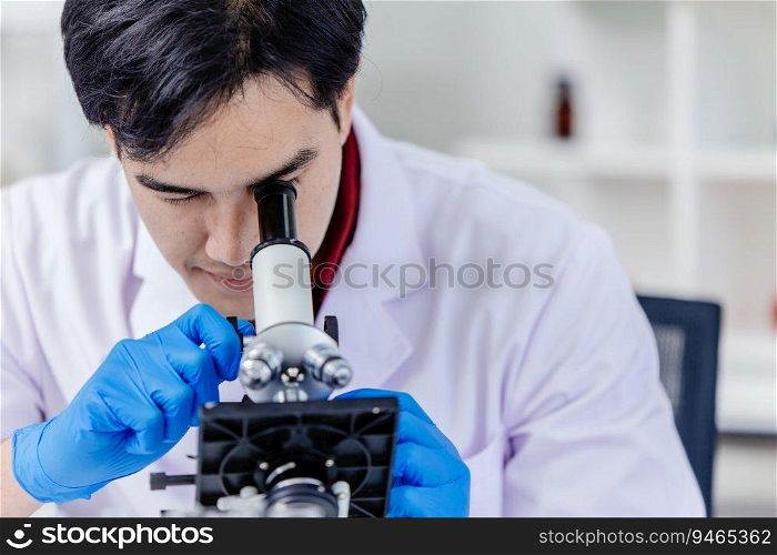 Asian scientist researcher looking at microscope working in medical lab.
