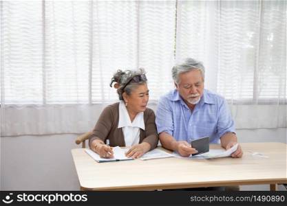 Asian senior couple serious worried with calculating bills to pay per month or debt, Retired elderly reading loan document, Money problems concept