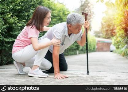 Asian senior man falling down at home in the backyard caused by myasthenia (Muscle Weakness) and the nurse came to help support. Concept of old elderly insurance and health care