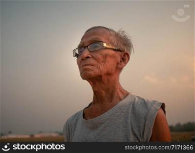 Asian senior man jogging in the park for good health. Healthcare concept.