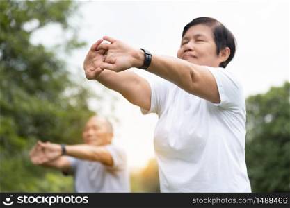 Asian senior people stretching their arms before exercising. Copy space. Good health.