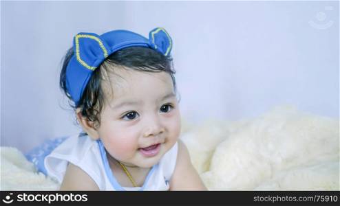 Asian Smiling baby girl . Asian Smiling baby girl crawling in bedroom