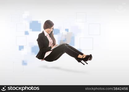 Asian smiling businesswoman with notebook is sitting on the floor over white isolated background