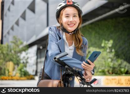 Asian smiling young woman with helmet hold mobile smart phone talk with business during go to office work at street with bicycle, Eco friendly, Lifestyle business female using bike outdoor in morning