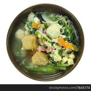 asian soup with pork, meatball , egg and mix vegetable in bowl over white background