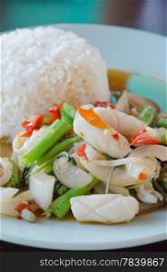 asian spicy cuisine , squid fried with chili pepper , mix vegetable served with rice