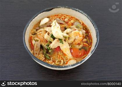 Asian spicy seafood noodle soup, Thai style instant seafood noodle soup, in ceramic bowl