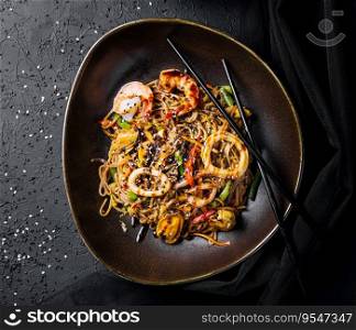 Asian spicy wok with noodles, shrimps and vegetables