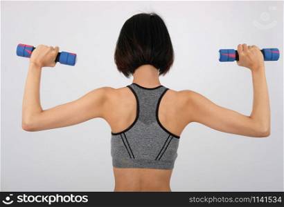 asian sporty woman in sportswear with dumbbell doing fitness workout on white background. healthy sport lifestyle