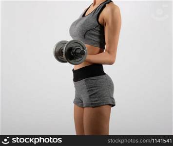 asian sporty woman in sportswear with dumbbell doing fitness workout on white background. healthy sport lifestyle