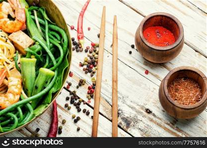 Asian tasty salad with shrimp, asparagus beans and okra.. Salad with seafood and vegetables.