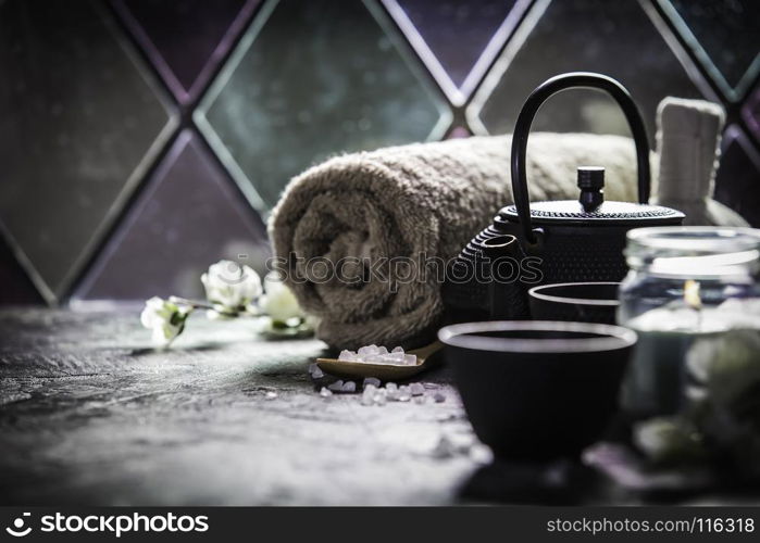 Asian tea set and spa settings on stone background near the old window. Natural spa treatment and relaxation concept