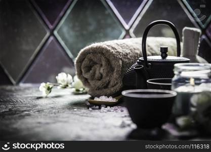 Asian tea set and spa settings on stone background near the old window. Natural spa treatment and relaxation concept