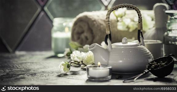 Asian tea set and spa settings on stone background near the old window. Natural spa treatment and relaxation concept