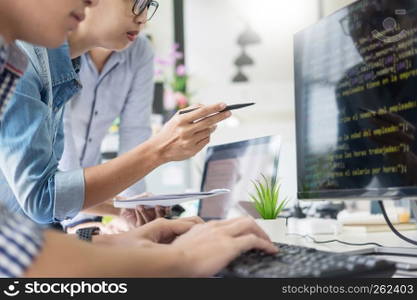 Asian team Outsource Developer Looking Screen Programming Code Working with Laptop Computer Software