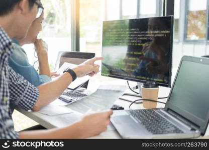 Asian team Outsource Developer Looking Screen Programming Code Working with Laptop Computer Software