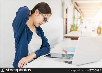 Asian teen girl neck pain. University woman hard work with laptop and reading book muscle cr&.