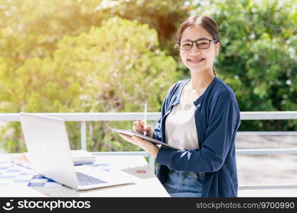 Asian teen girl with laptop computer for online education learning or programmer student in university.