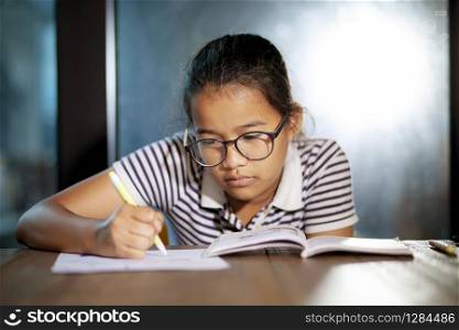 asian teenager doing school homework